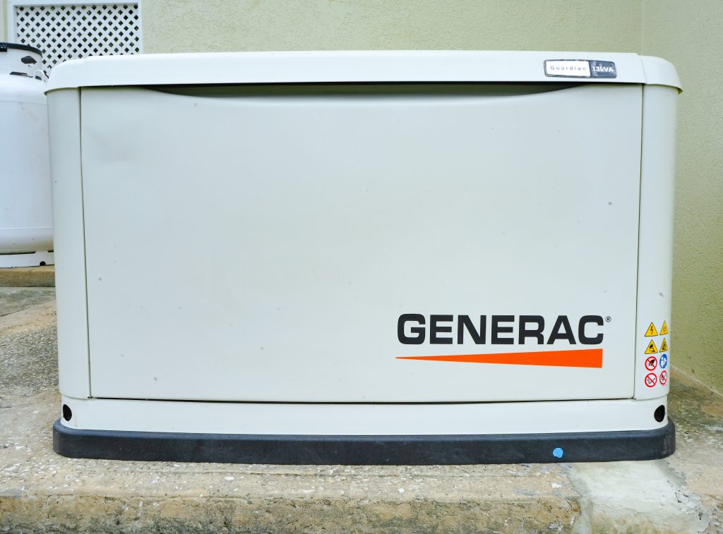 Generac standby generator installed outdoors on a concrete platform.